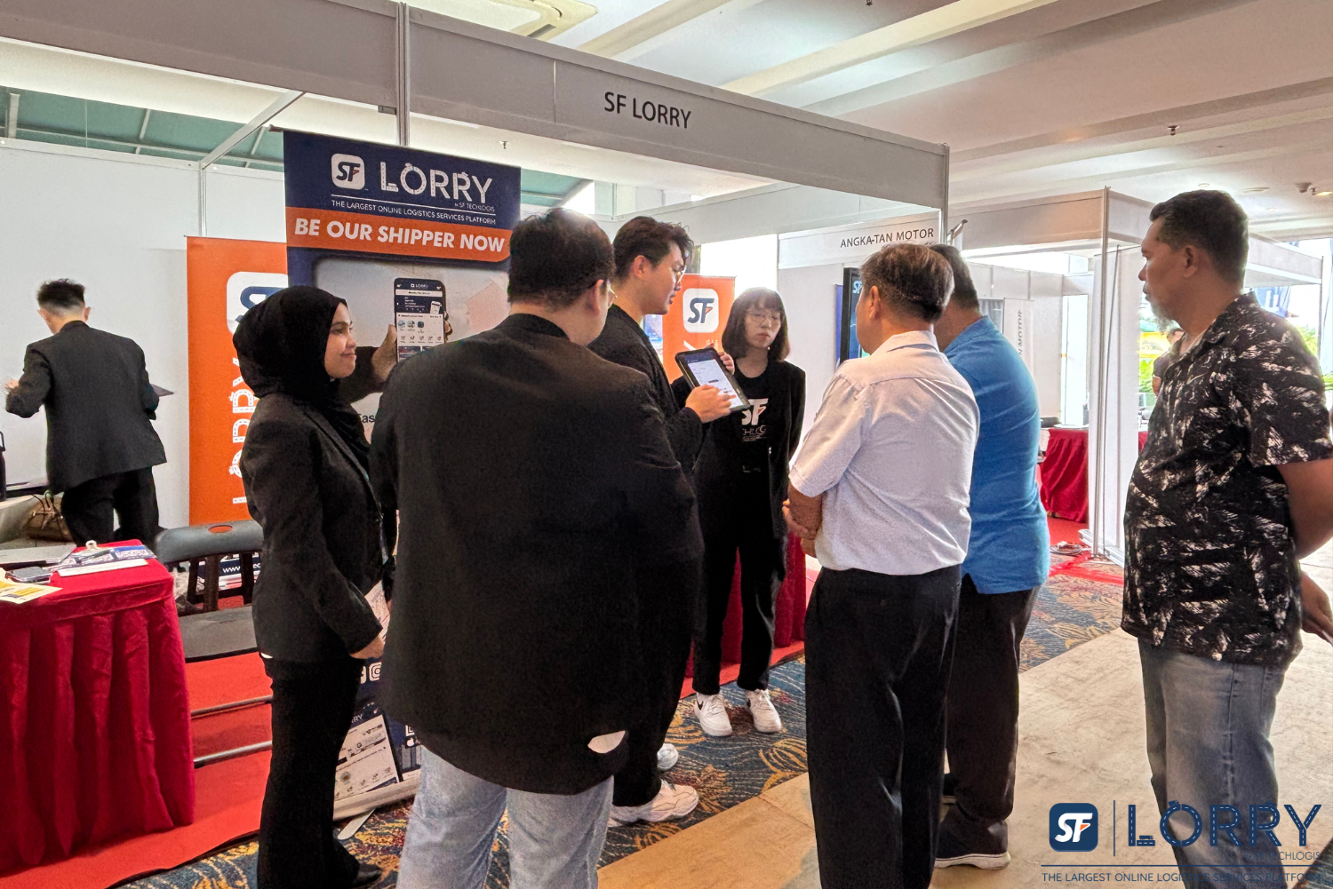 SF Lorry team presenting digital truck Malaysia solutions at Johor logistics exhibition 2024